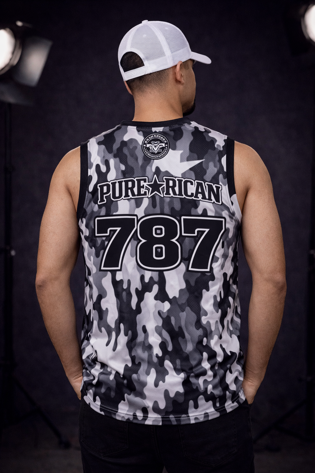 Male model in straight back power stance wearing Pure⭐️Rican 787 camo jersey highlighting Puerto Rico area code design.