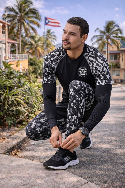 Male model wearing Pure⭐️Rican Boricua shadow camo leggings tying shoe on tropical street