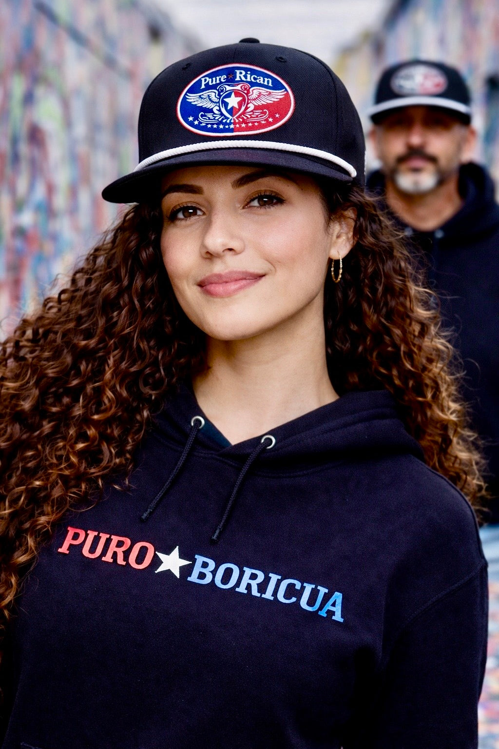 Male model wearing Pure⭐️Rican black rope snapback hat in urban graffiti alley with embroidered front emblem.