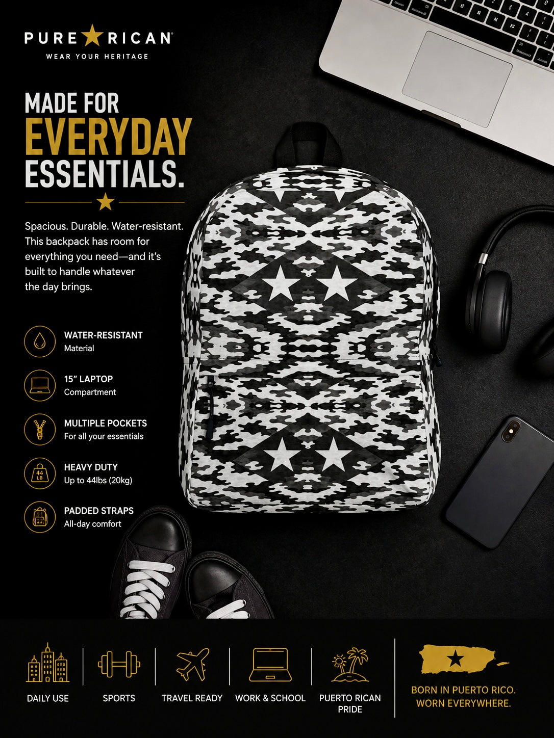 Flat lay image of the Pure⭐️Rican Black Heritage Camo backpack styled with everyday essentials including headphones, laptop, sneakers, and phone.