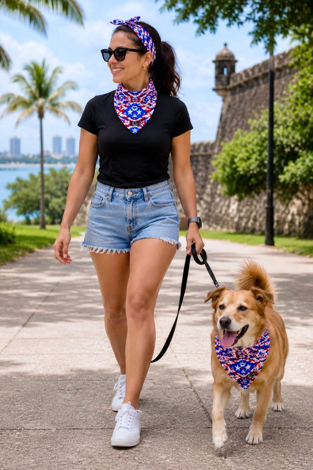 Female model walking a dog while wearing the Pure⭐️Rican patriotic camo headband and neck bandana in an outdoor lifestyle setting.
