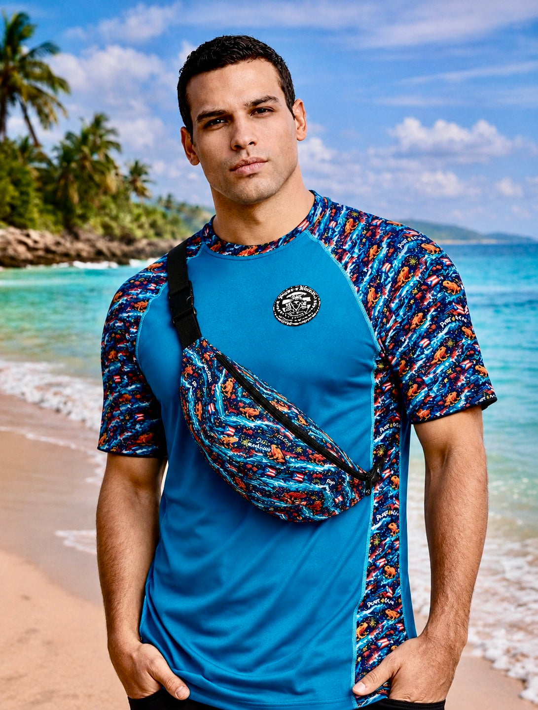 Male beach lifestyle model wearing Pure⭐️Rican Sapo Wave Galaxy Fanny Pack with matching tropical rash guard on a Puerto Rican-inspired beach setting, showcasing crossbody everyday travel style.