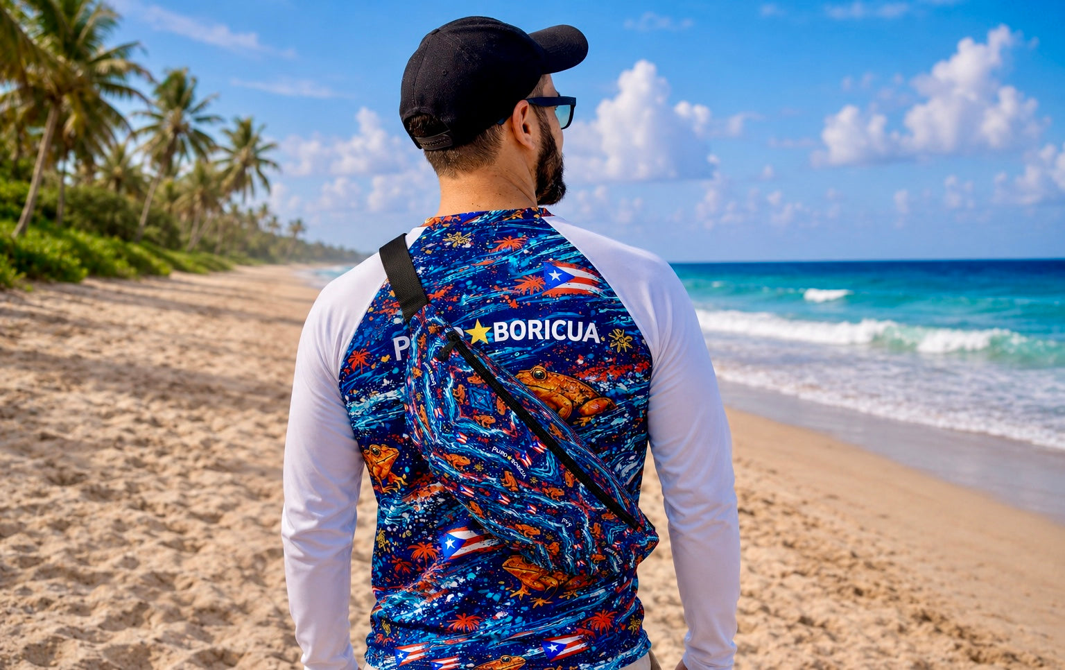 Pure⭐️Rican Sapo Wave Fanny Pack worn crossbody on the beach featuring vibrant Puerto Rican flag accents, ocean-inspired artwork, and signature Sapo Concho frog pattern.